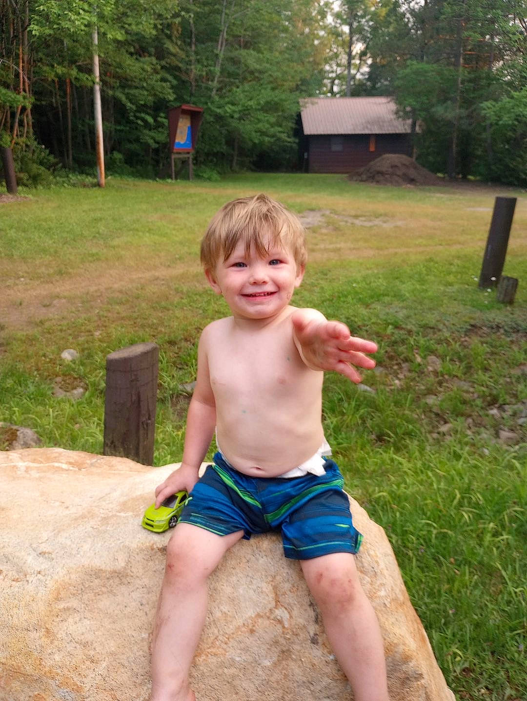 Mathew is registered to the contest to win money with this photo: barechested, barefoot, chest, fun, garden, grass, human_leg, joy, lawn, leisure, people_in_nature, person, plant, recreation, sitting, smile, soil, thigh, thumb, toddler