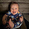 baby, baby_seat, barefoot, cartoon_clothing, child, colorful, couch, face, feet, hands, happy, home, indoor, infant, laughing, pajamas, portrait, sitting, smiling, sofa