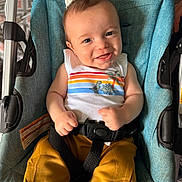 Patrick joined the competition — help win amazing prizes! baby, child, dinosaur, eyes, face, family, hands, happy, harness, infant, outdoor_gear, photography, portrait, seated, smiling, striped_shirt, stroller, turquoise_fabric, vehicle_seat, yellow_pants