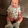 Patrick is registered to the contest to win money with this photo: baby, bracelet, carpet, child, close_up, couch, cute, fashion, floral_shirt, happy, indoor, infant, photography, portrait, shorts, sitting, smiling, sneakers, socks, tongue_out