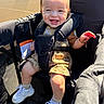 Patrick joined the competition — help win amazing prizes! baby, bracelet, carriage, child, eyes, face, family, happy, harness, infant, outdoor, photography, portrait, romper, seated, smiling, sneakers, stroller, sunlight, teeth