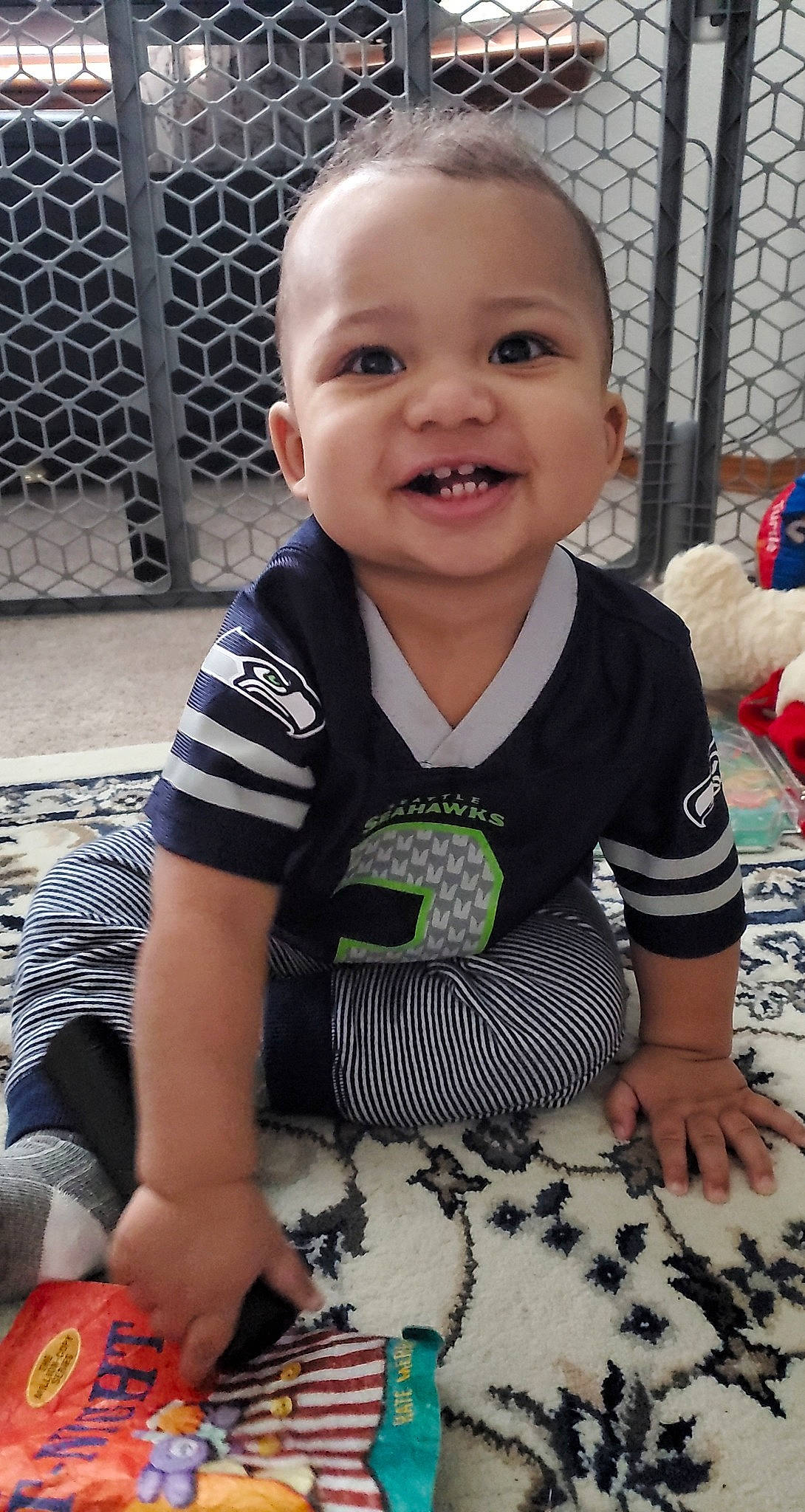 Lj is registered to the contest to win money with this photo: baby, baby_products, baby_toddler_clothing, cheek, child, flooring, fun, grass, happy, joy, mammal, pattern, person, play, recreation, sitting, skin, sleeve, smile, summer