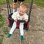 toddler, child, swing, playground, smiling, happy, outdoor, grass, adult, dog, fence, rubber_tiles, clothing, socks, person, fun, play, joy, nature, daytime