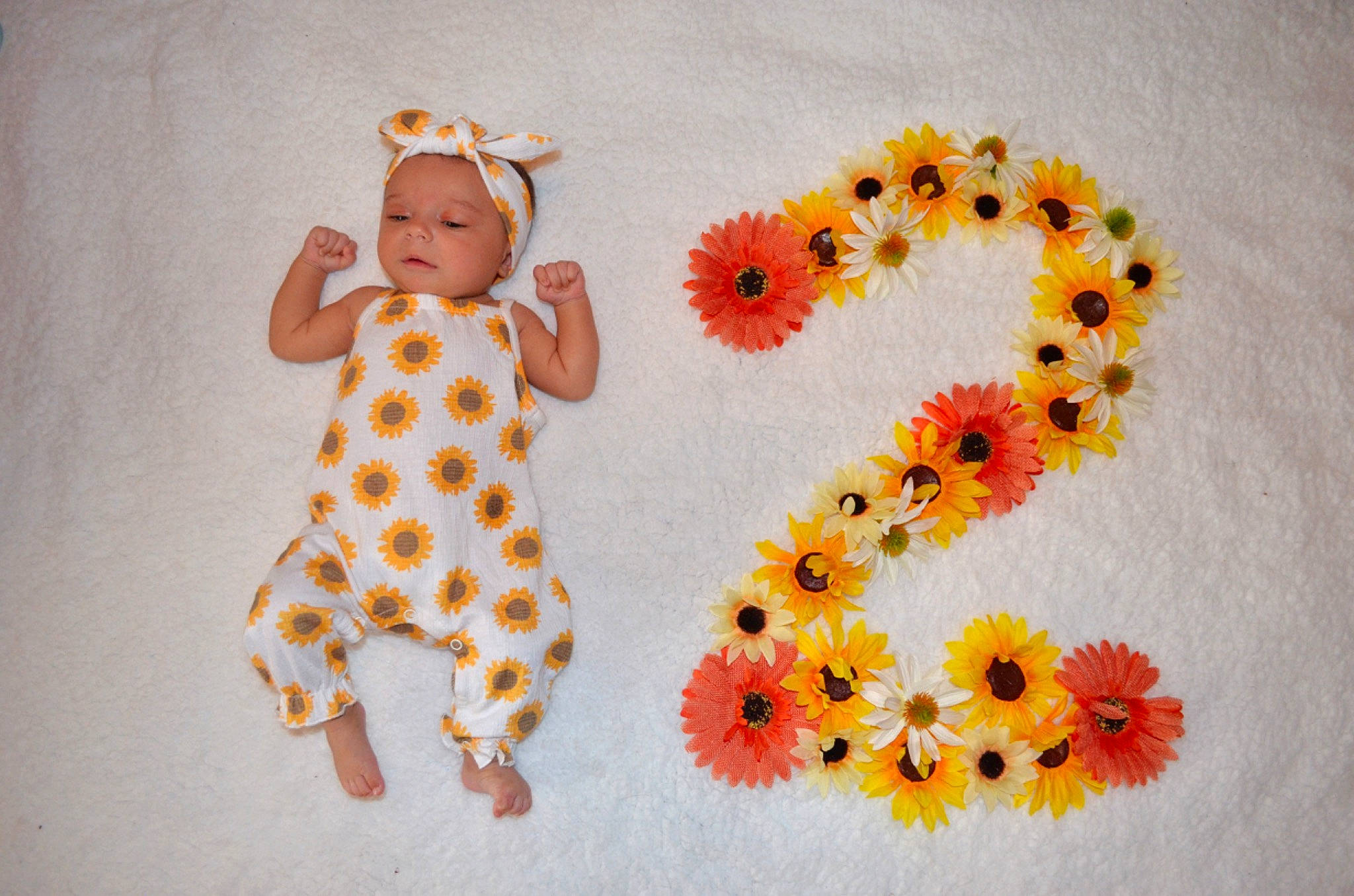 Amarah is registered to the contest to win money with this photo: baby, baby_toddler_clothing, cut_flowers, flooring, floral_design, flower, flower_arranging, font, happy, headgear, headwear, linens, orange, pattern, pedicel, person, petal, plant, sleeve, t_shirt