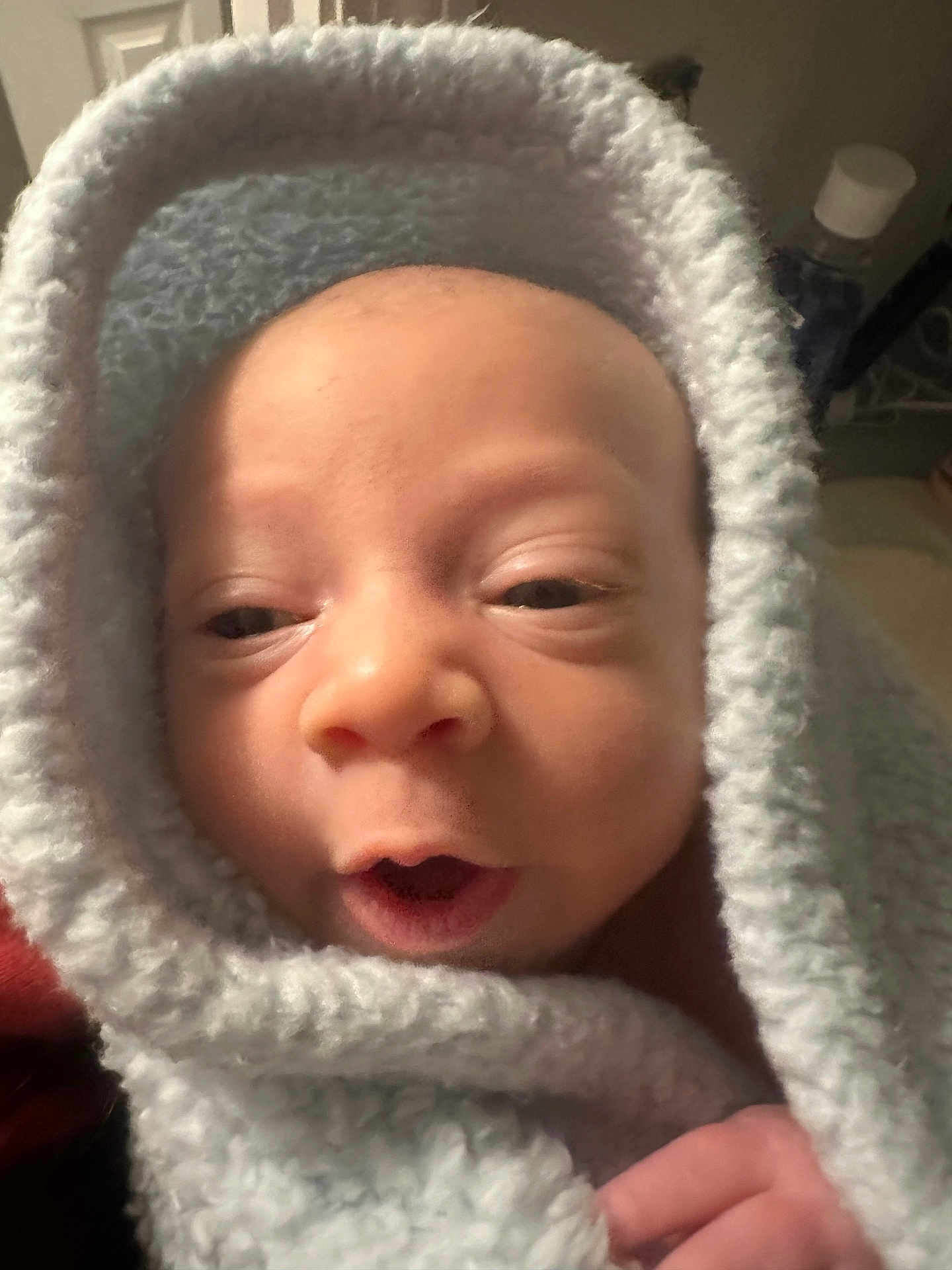 Nolan joined the competition — help win amazing prizes! baby, blanket, close_up, face, infant, indoor, soft_texture, wrapped, newborn, cute, expression, hand, skin, warm, comfort, head, portrait, child, young, cozy