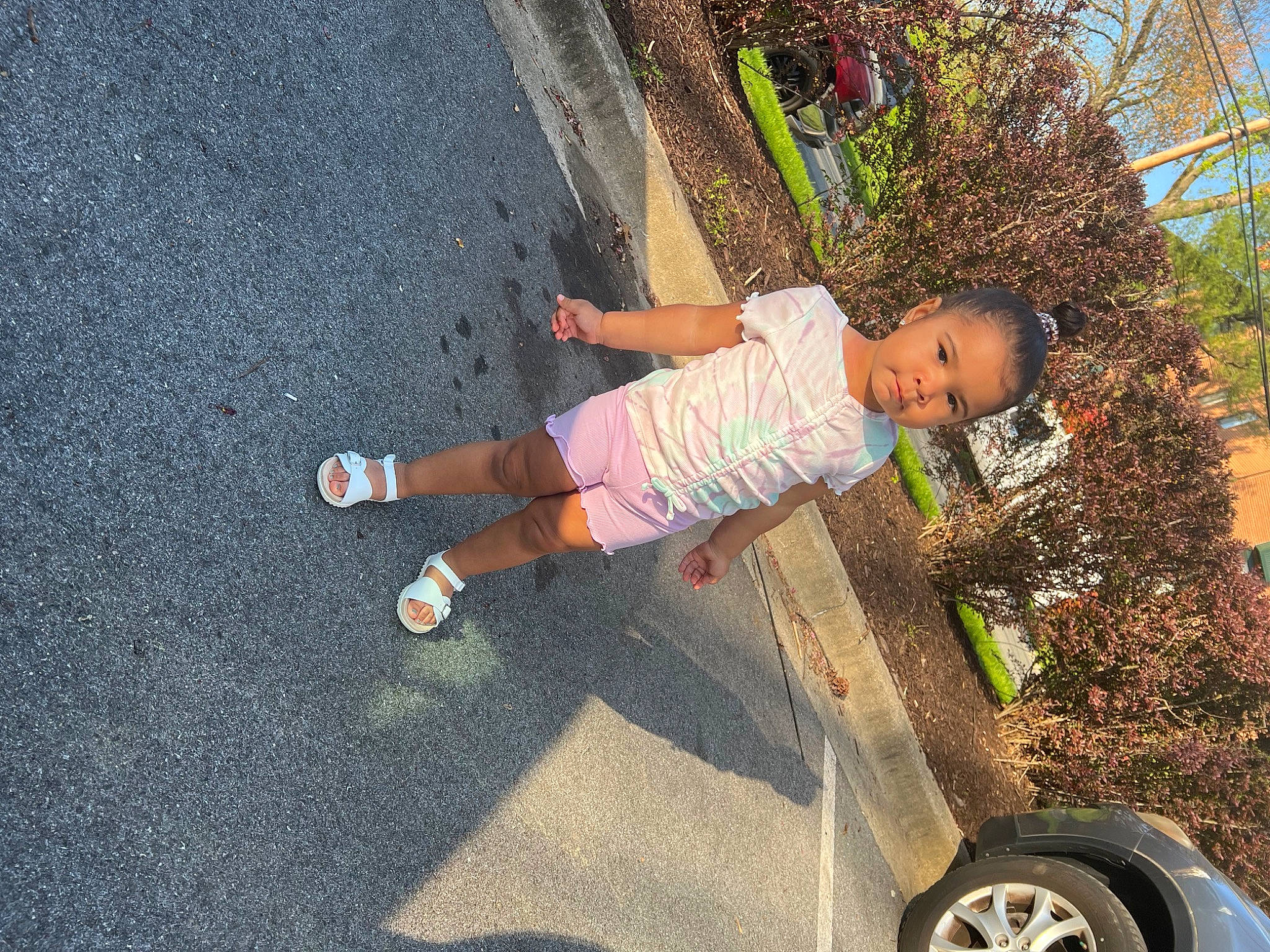 Leilanni joined the competition — help win amazing prizes! asphalt, automotive_tire, child, city, fun, grass, leisure, people_in_nature, person, plant, play, recreation, road_surface, shorts, sidewalk, sneakers, soil, tire, toddler, tree