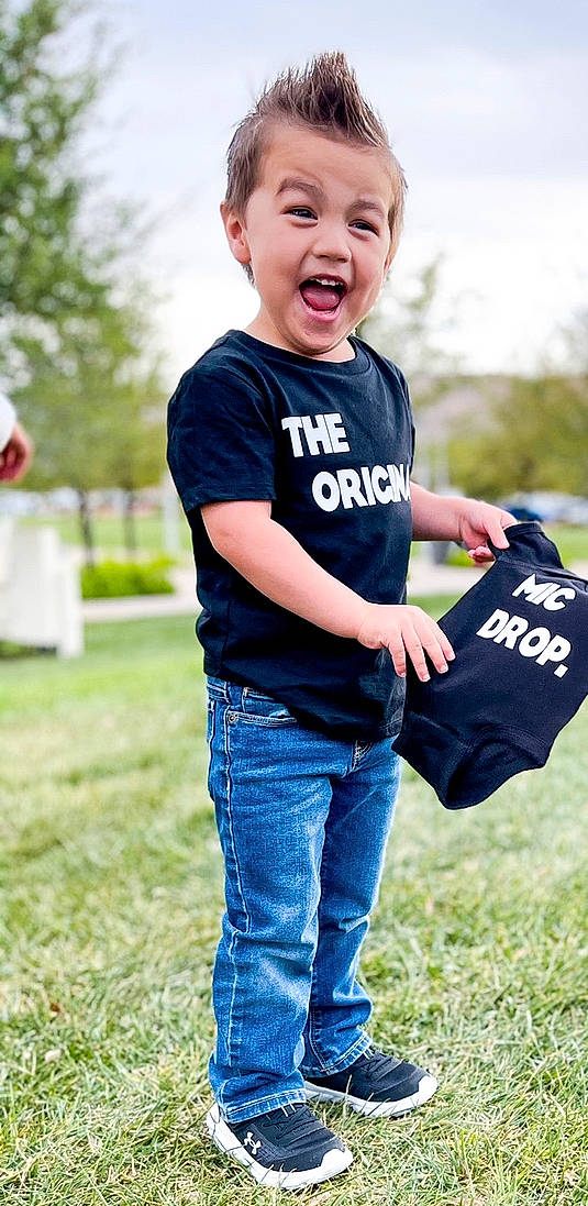 Joshua Jr. joined the competition — help win amazing prizes! arm, clothing, cool, daytime, facial_expression, flash_photography, gesture, grass, hand, happy, jeans, people_in_nature, person, photograph, plant, red, sky, sleeve, sunlight, tree