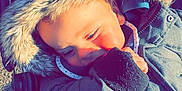 Gabryell participe au concours pour gagner de l'argent avec cette photo : baby, baggage, blonde, clothing, coat, cream, dessert, eating, face, food, glove, head, hood, icecream, jacket, person, photography, portrait, sleeping, sweets