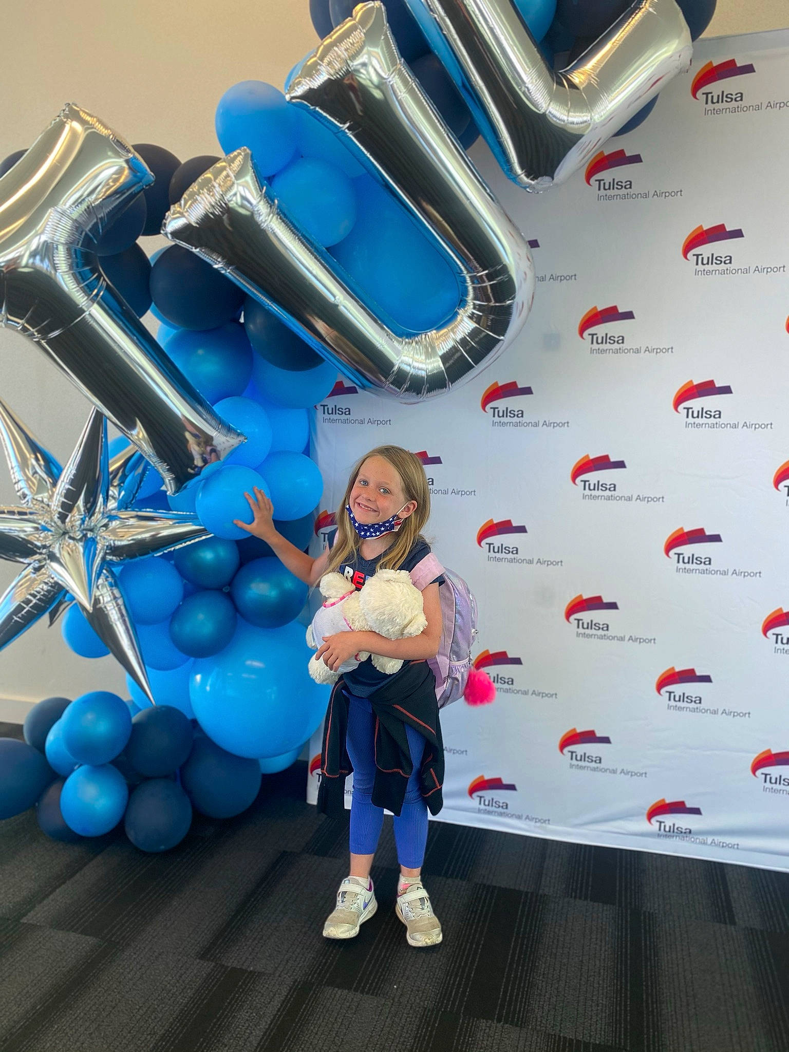 Kennedy is registered to the contest to win money with this photo: advertising, automotive_design, balloon, boot, electric_blue, event, flooring, fun, happy, joy, leisure, machine, mobile_phone, party_supply, person, personal_protective_equipment, product, recreation, shoe, smile