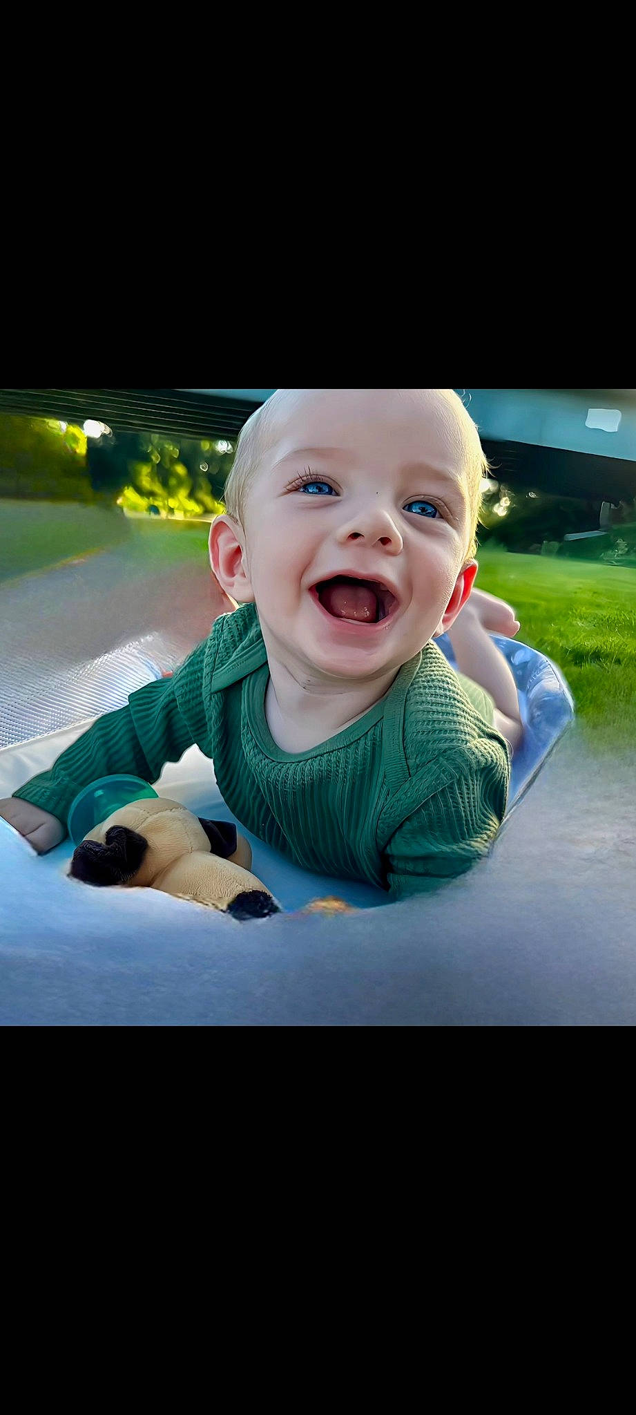 Warren is registered to the contest to win money with this photo: arm, baby, baby_toddler_clothing, child, comfort, cool, facial_expression, flash_photography, fun, gesture, grass, happy, leisure, mouth, person, plant, sitting, sleeve, smile, t_shirt