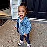 Charleigh joined the competition — help win amazing prizes! child, toddler, girl, smiling, happy, portrait, standing, outdoors, front_door, entrance, porch, denim_jacket, sneakers, curly_hair, hair_bun, fashion, clothing, driveway, home, daylight