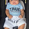 Rhys joined the competition — help win amazing prizes! baby, bare_feet, black_car_seat, blue_shirt, car_seat, child, close_up, clothing, curly_hair, front_facing, indoor, infant, photography, portrait, safe, seated, serious_expression, white_shorts, wide_eyed, young_child