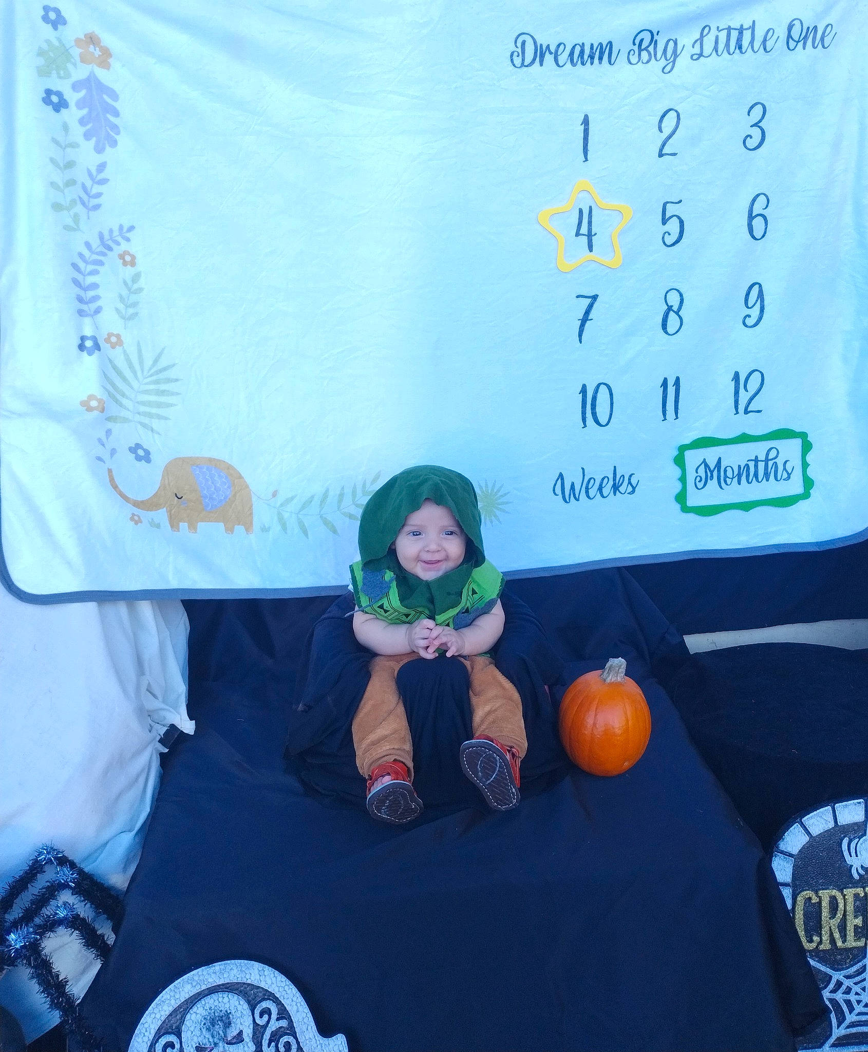 Emory is registered to the contest to win money with this photo: advertising, animation, brand, child, display_device, electric_blue, event, flooring, font, fun, headwear, joy, linens, logo, multimedia, person, recreation, room, t_shirt, toddler