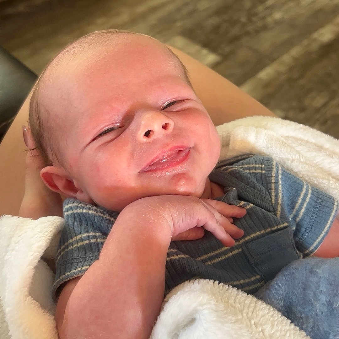 Agon joined the competition — help win amazing prizes! baby, blanket, blue_shirt, clothing, comfort, cute, face, floor, hand, human, indoor, infant, newborn, person, portrait, resting, skin, smile, soft, warmth