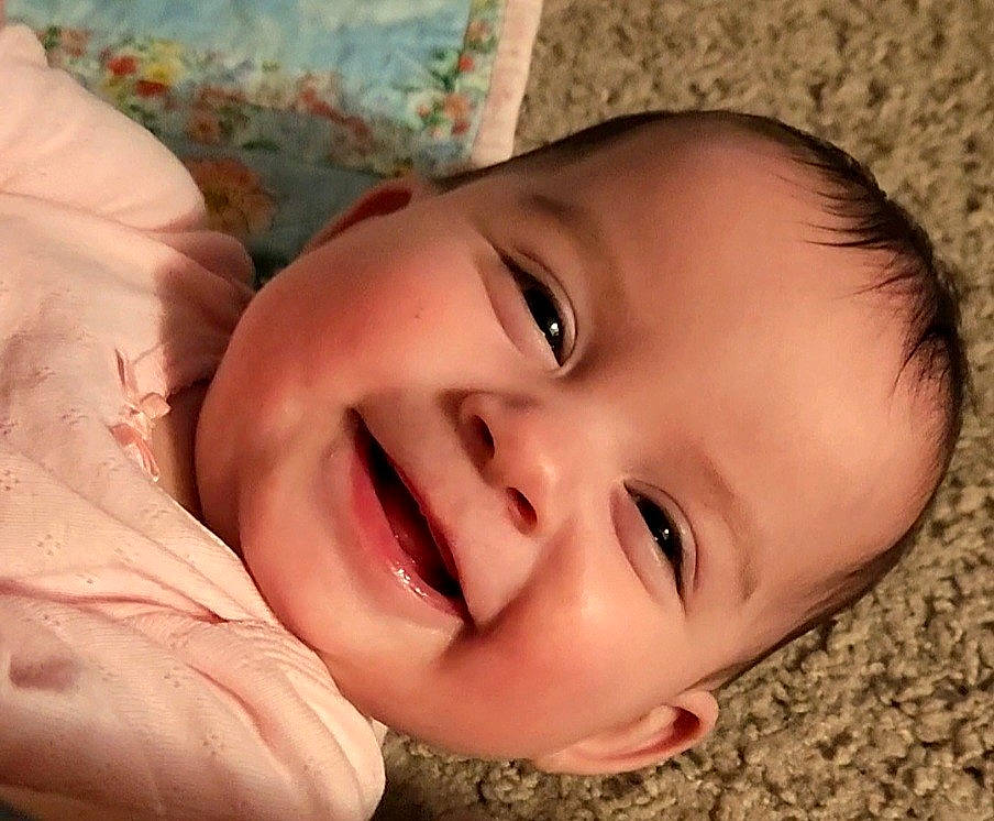 Ada is registered to the contest to win money with this photo: baby, baby_laughing, cheek, child, close_up, eye, eyebrow, eyelash, gesture, grass, hair, happy, iris, joy, lip, mouth, nose, person, plant, skin