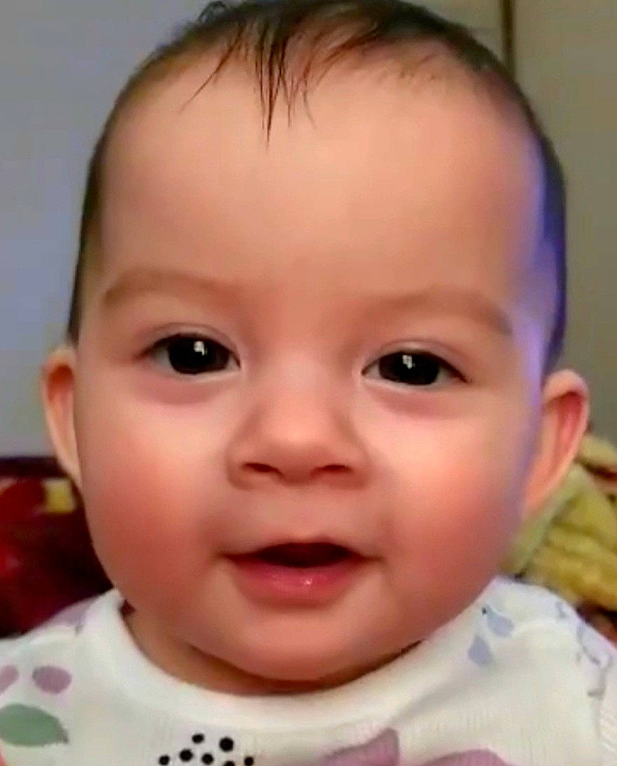 Ada is registered to the contest to win money with this photo: baby, cheek, chin, collar, ear, eyebrow, eyelash, forehead, gesture, happy, iris, jaw, lip, mouth, neck, nose, person, skin, sleeve, smile