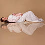 Mia a rejoint le concours — aidez-le/la à gagner de superbes lots ! woman, baby, maternity, pregnant, reflection, white_dress, lace, infant, lying_down, headband, studio, portrait, soft_lighting, calm, mother, newborn, beige_background, elegant, peaceful, artistic