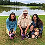 Duchess joined the competition — help win amazing prizes! people, dog, grass, lake, trees, water, outdoor, pet, leash, harness, smiling, woman, man, casual_clothing, nature, park, summer, happy, group, scenic
