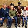 Luna Mom joined the competition — help win amazing prizes! group, people, smiling, sitting, indoor, casual_clothing, dog, small_dog, graduation_cap, celebration, happy, jeans, sneakers, woman, man, middle_aged, young_adult, pet, chair, tiled_wall