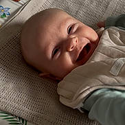 Erin joined the competition — help win amazing prizes! baby, smiling, face, blanket, knitted, clothing, lying_down, happy, infant, portrait, cute, indoors, fabric, child, young, person, head, skin, expression, comfort