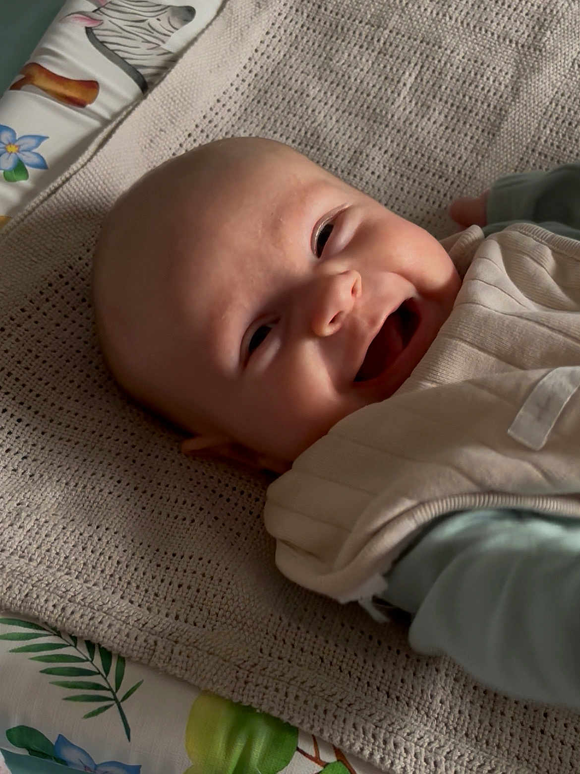 Erin joined the competition — help win amazing prizes! baby, smiling, face, blanket, knitted, clothing, lying_down, happy, infant, portrait, cute, indoors, fabric, child, young, person, head, skin, expression, comfort