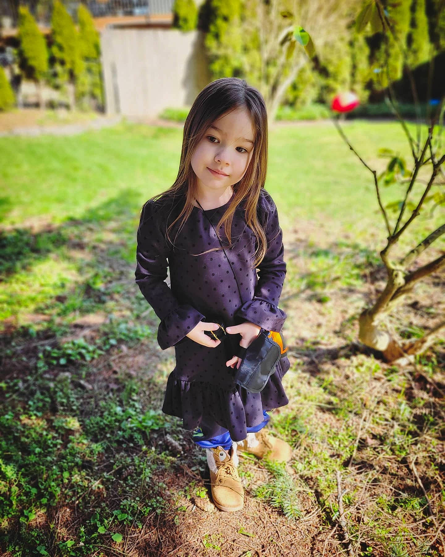 Baylie is registered to the contest to win money with this photo: black_hair, electric_blue, fawn, forest, formal_wear, grass, grass_family, grassland, hair, happy, long_hair, people_in_nature, person, plaid, plant, shoe, smile, street_fashion, toddler, tree