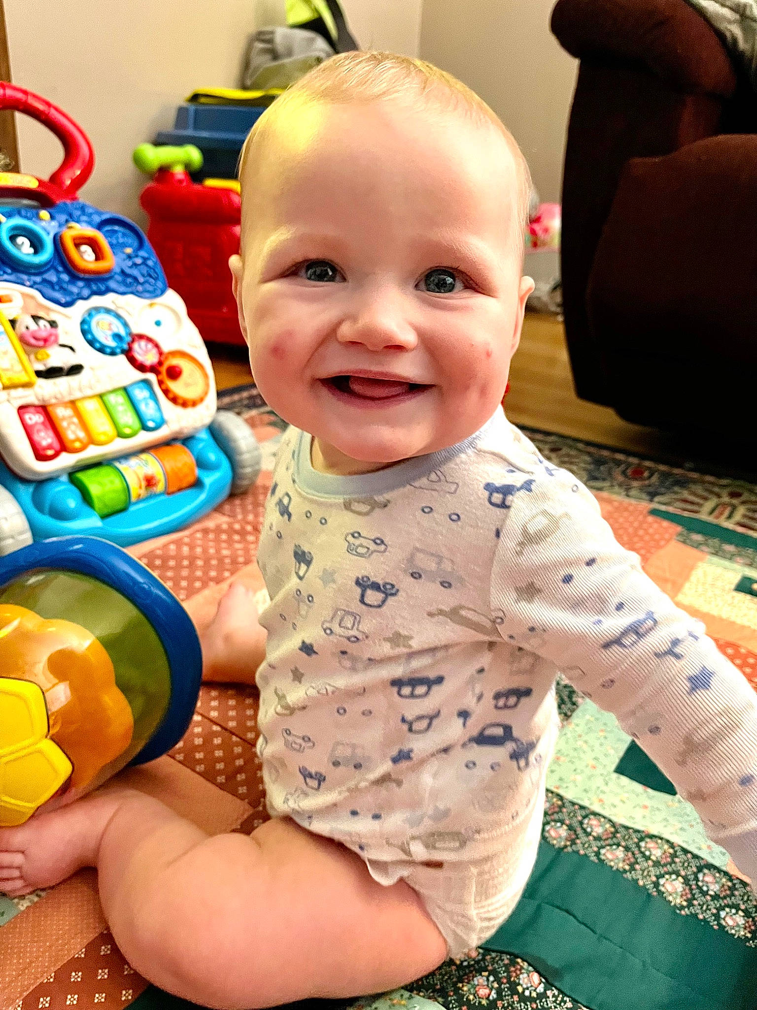 Kaleb joined the competition — help win amazing prizes! baby, baby_playing_with_toys, baby_products, baby_toddler_clothing, cheek, child, comfort, fun, happy, head, joy, person, photograph, product, sitting, skin, sleeve, smile, t_shirt, textile