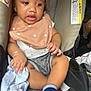 Terrell is registered to the contest to win money with this photo: baby, child, car_seat, bib, blanket, sock, clothing, bracelet, infant, seatbelt, person, cute, indoor, portrait, comfort, soft_toys, casual, relaxed, young, holding