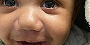 Terrell joined the competition — help win amazing prizes! baby, close_up, smile, face, eyes, blanket, infant, joy, expression, cute, child, warm, soft_texture, wrapped, happy, skin, mouth, portrait, newborn, adorable
