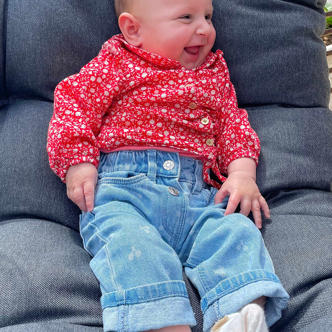 Amélia participe au concours pour gagner de l'argent avec cette photo : baby, baby_girl, buttoned_shirt, casual_clothing, chair, child, cozy, cushion, cute, denim, happy, indoors, infant, jeans, portrait, red_clothing, relaxed, seated, smiling, socks