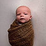 baby, infant, wrapped, blanket, brown, cozy, portrait, face, newborn, cute, soft, knit, child, person, expression, indoor, bundle, skin, head, small