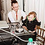 Ronald joined the competition — help win amazing prizes! toddler, child, man, headphones, dj_equipment, tuxedo, smile, party, event, indoor, person, technology, music, table, chair, curtain, glasses, cable, bottle, hand