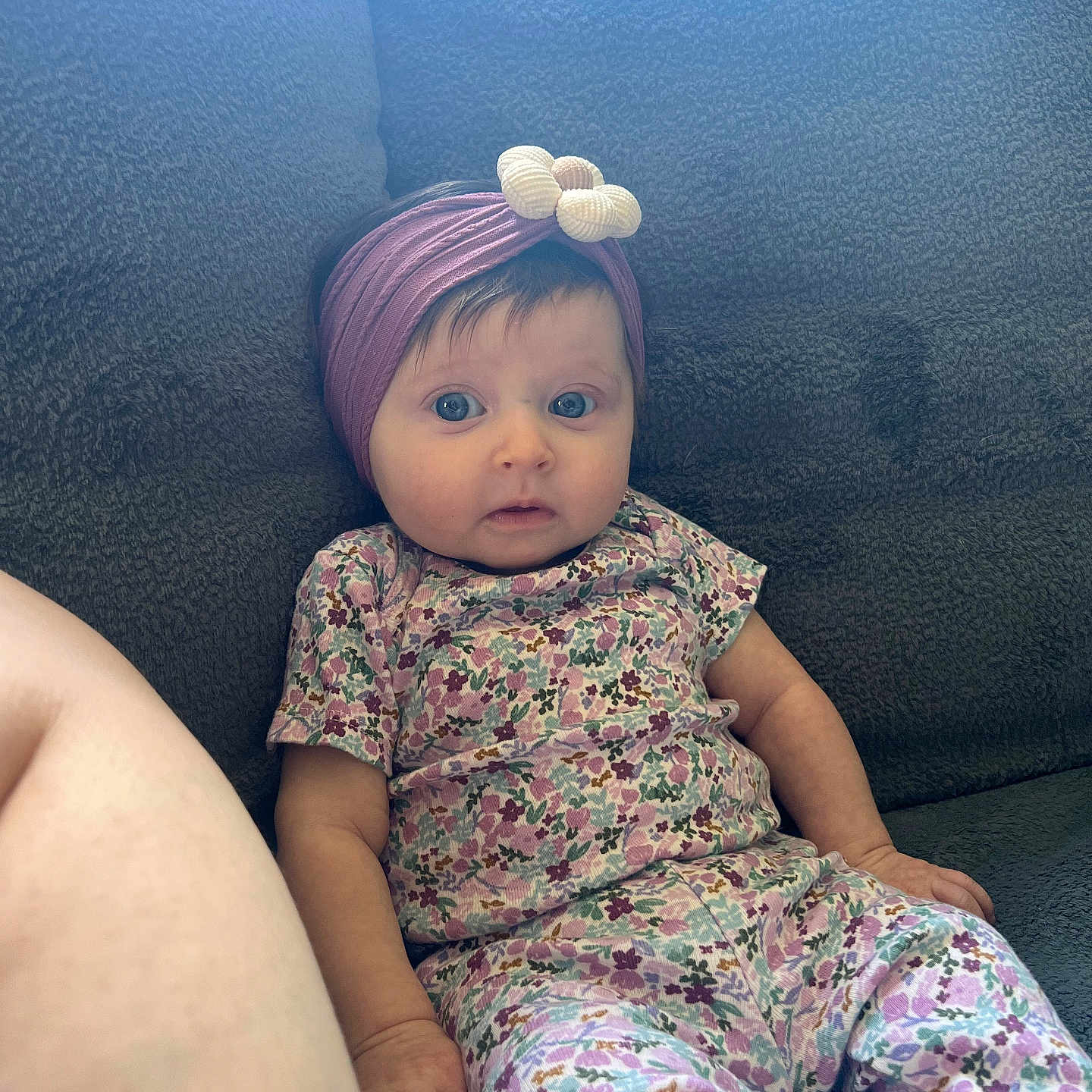 Valentina joined the competition — help win amazing prizes! baby, blue_eyes, bow, casual, child, comfort, couch, curious, finger, floral_outfit, gray, hand, headband, indoor, nail_paint, person, purple, seated, soft_texture, young_child