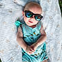 baby, sunglasses, blanket, outdoor, grass, infant, onesie, dinosaur_pattern, reflection, hands, cute, child, casual, sunny, relaxing, portrait, young, wearing, fashion, summer