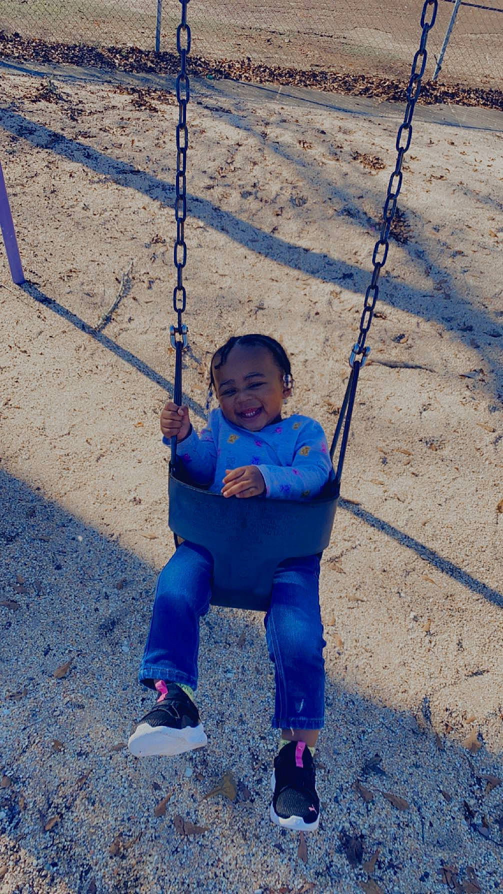 Maleah joined the competition — help win amazing prizes! baby, baby_toddler_clothing, blue, child, city, electric_blue, fun, grass, happy, joy, leisure, outdoor_play_equipment, people_in_nature, person, plant, playground, recreation, sitting, smile, swing