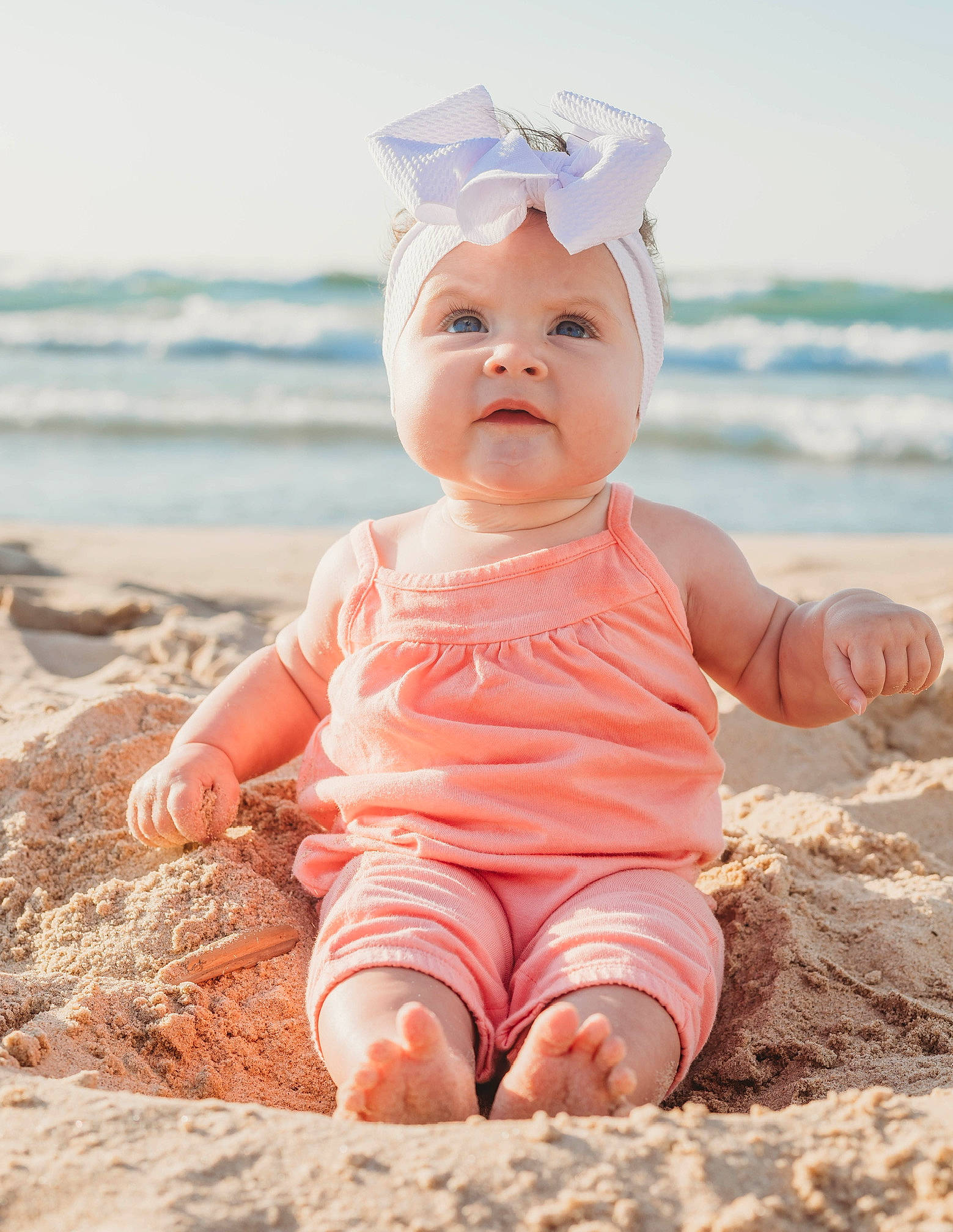 Oaklynn is registered to the contest to win money with this photo: baby, baby_toddler_clothing, beach, beauty, child, fashion_accessory, fun, grass, happy, hat, headwear, people_in_nature, person, photograph, pink, sand, sitting, sky, sleeve, sunlight