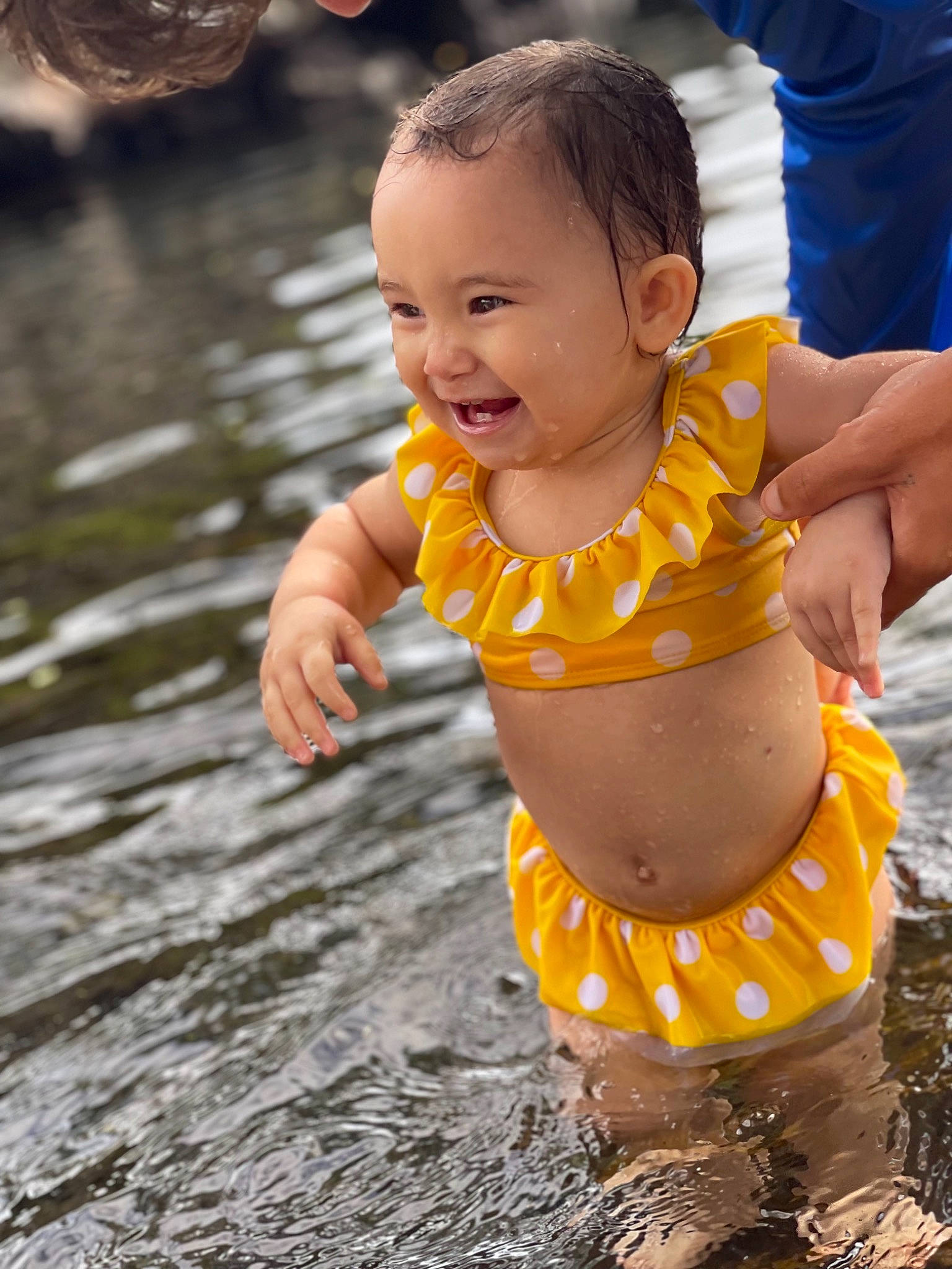 Jenya is registered to the contest to win money with this photo: abdomen, body_of_water, child, event, eye, face, fun, hand, happy, head, leisure, nature, navel, people_in_nature, person, recreation, shorts, smile, toddler, trunk
