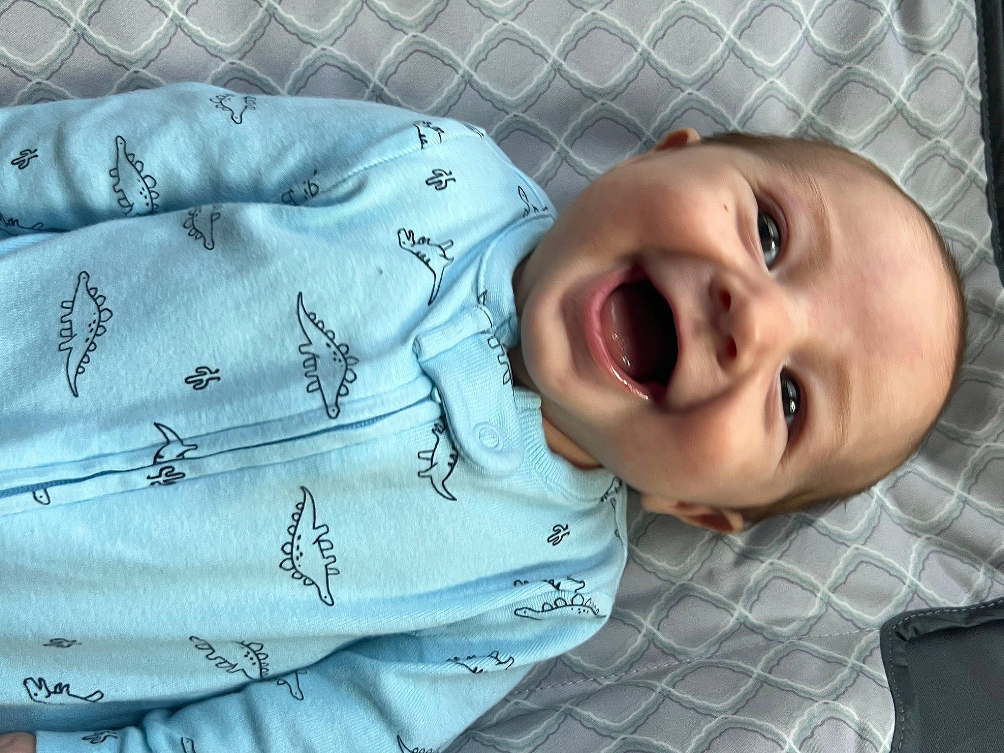 James is registered to the contest to win money with this photo: baby, baby_laughing, baby_toddler_clothing, cheek, child, comfort, eyebrow, facial_expression, happy, iris, linens, lip, mouth, nose, organ, person, skin, sleeve, smile, textile