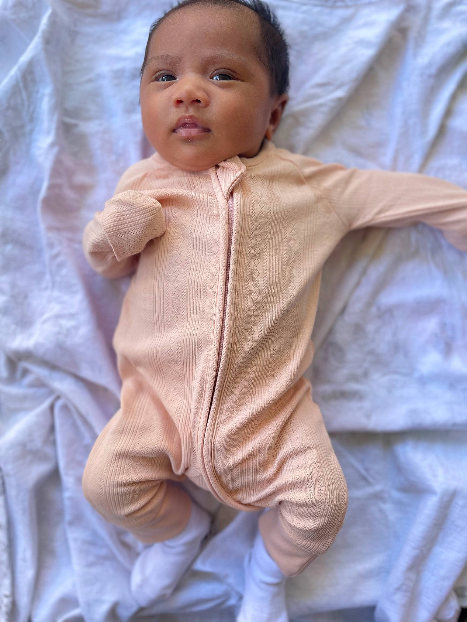 Alira is registered to the contest to win money with this photo: baby, baby_toddler_clothing, cheek, child, comfort, finger, fur, gesture, hand, happy, human_body, knitting, linens, outerwear, person, sitting, skin, sleeve, thumb, toddler