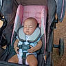 Raven is registered to the contest to win money with this photo: baby, canopy, closed_eyes, face, harness, infant, nap, onesie, outdoor, pavement, peaceful, pink_stroller, portrait, safety_belt, seated, sleeping, stroller, summer, sunlight, wheel