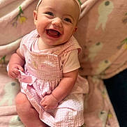 Jessalynn joined the competition — help win amazing prizes! baby, child, infant, smiling, happy, portrait, pink_outfit, dress, headband, bow, sitting, indoors, nursery, blanket, soft_lighting, closeup, face, laughing, cozy, photography