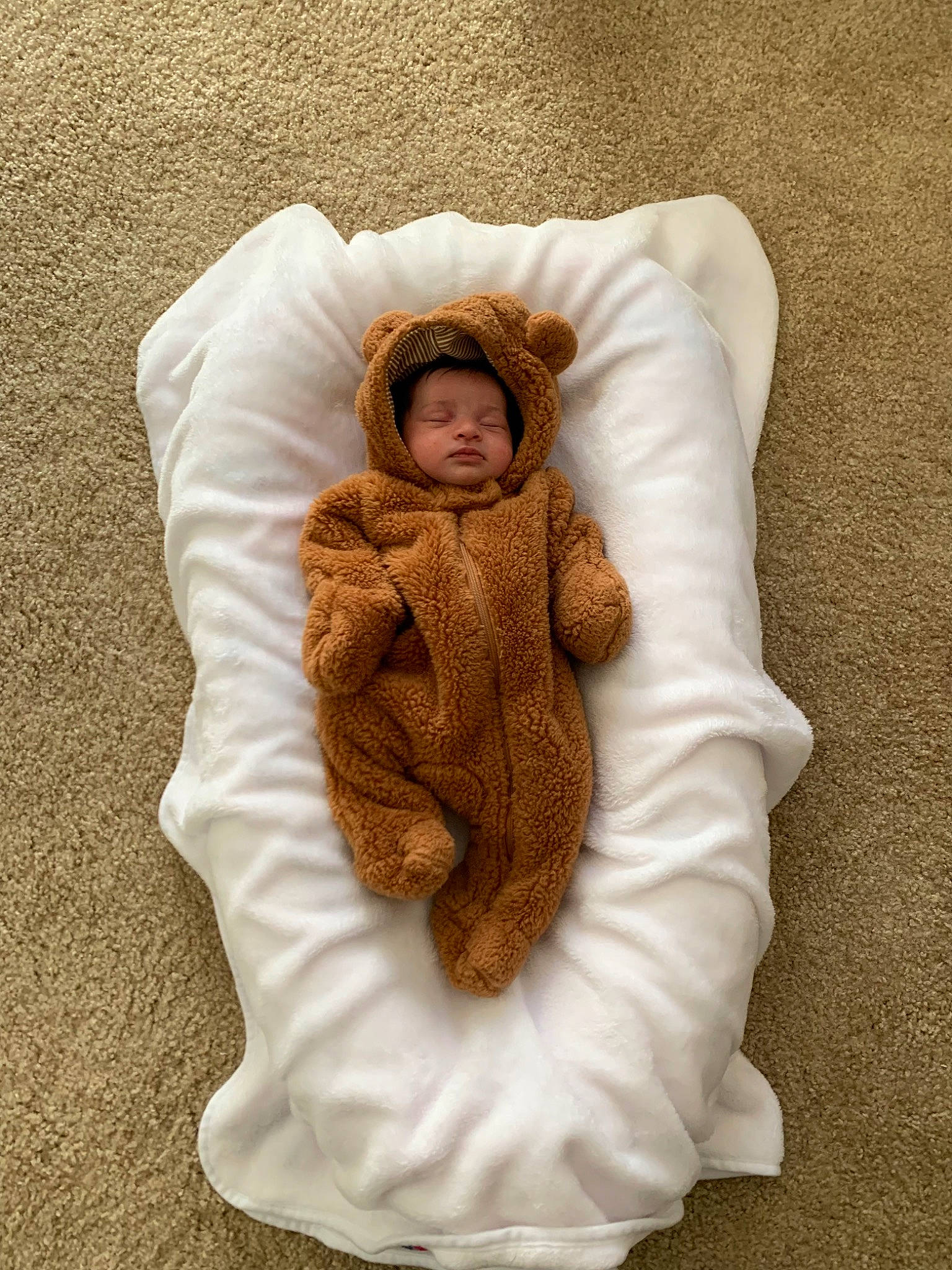 Kehlani is registered to the contest to win money with this photo: baby, baby_products, baby_sleeping, baby_toddler_clothing, bedding, beige, child, clothing, comfort, face, fur, headgear, linens, outerwear, person, sitting, skin, sleeve, textile, toddler