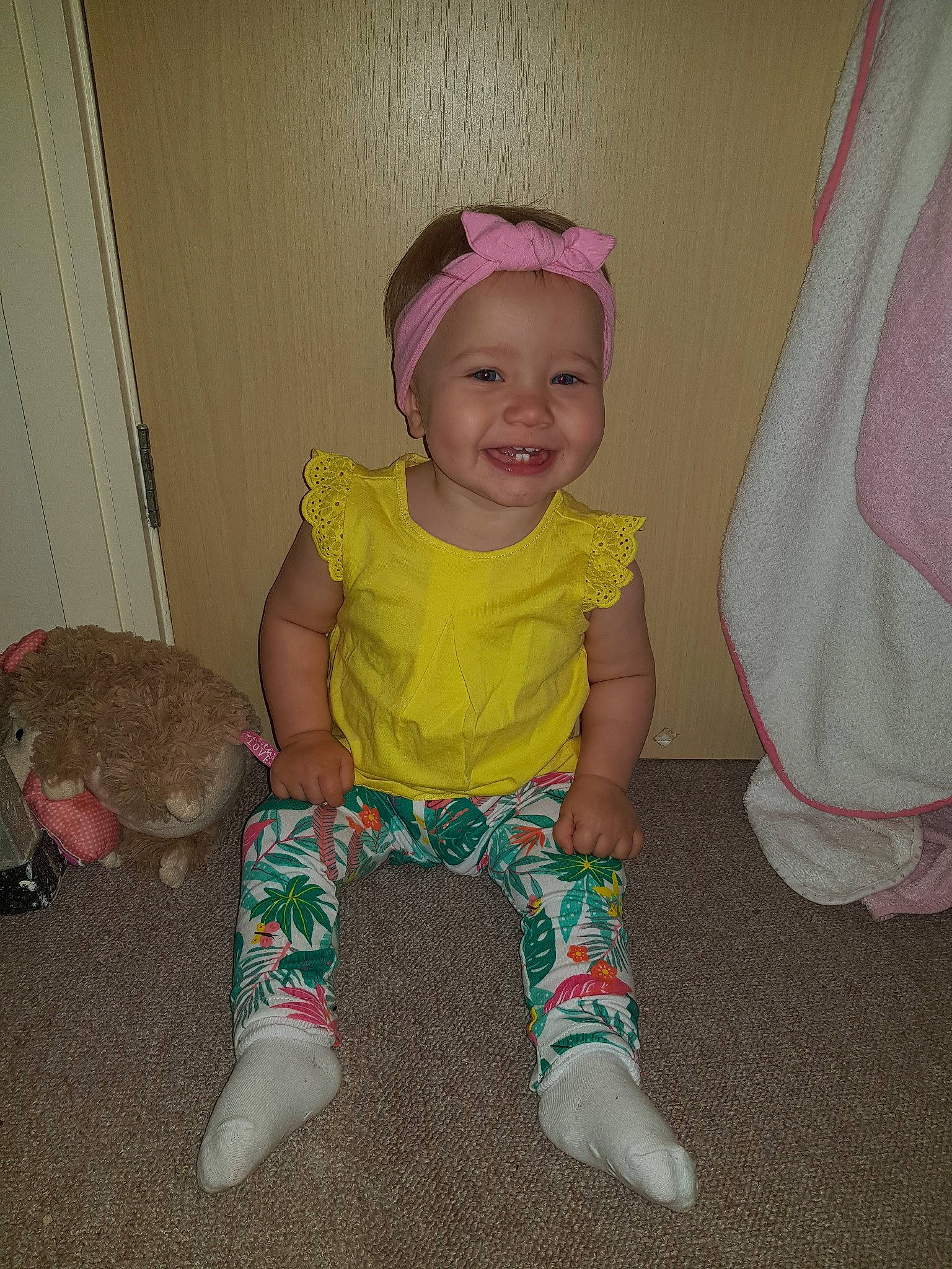 Peyton is registered to the contest to win money with this photo: baby_toddler_clothing, child, joy, person, pink, play, sitting, standing, toddler