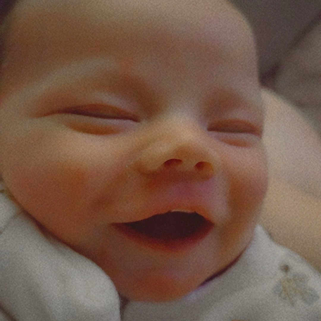 Cainan is registered to the contest to win money with this photo: baby, bed, bedroom, bodypart, cushion, face, furniture, happy, head, homedecor, laughing, mouth, newborn, person, photography, portrait, quilt, sleeping, smile, teeth