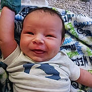 Wesley joined the competition — help win amazing prizes! baby, smiling, infant, blanket, clothing, dinosaur_print, mittens, happy, cute, lying_down, face, child, toddler, indoors, carpet, apparel, portrait, skin, expression, young
