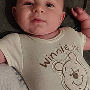 Colson joined the competition — help win amazing prizes! baby, background, child, clothing, curious, cute, expression, fabric, face, hand, head, infant, lying_down, onesie, person, portrait, skin, sleepy, toddler, winnie_the_pooh