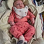 baby, baby_bib, blanket, child, cozy, cute, cute_outfit, floral_pattern, indoor, infant, newborn, pink_clothing, portrait, resting, sleeping, small_hands, socks, soft_texture, warm, wrapped