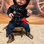 child, toddler, cowboy_costume, cowboy_hat, sheriff_badge, red_bandana, cowboy_boots, jeans, navy_shirt, wooden_stool, western_backdrop, wagon_wheel, hay, blanket, portrait, sitting, indoor, adorable, cute_expression, photoshoot