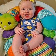 Winter joined the competition — help win amazing prizes! baby, child, smiling, headband, yellow_bow, colorful_cushion, plush_toy, happy, cute, indoors, seated, blue_onesie, patterned_clothing, infant, person, portrait, soft_toy, bright_colors, cheerful, baby_feet