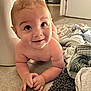 baby, child, tummy, floor, tiled_floor, smile, curious, towel, rug, indoors, person, skin, hands, wide_eyes, head, hair, home, door, hallway, cozy